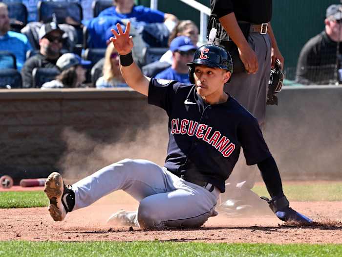 Apr 11, 2022; Kansas City, Missouri, USA; Cleveland Guardians left fielder Steven Kwan (38) slides home, scoring a run during the seventh inning against the Kansas City Royals at Kauffman Stadium.